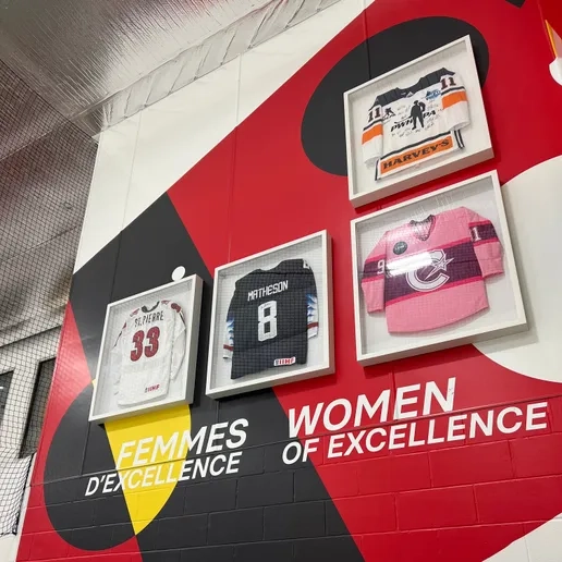 Women of excellence wall at Hockey Etcetera with 4 jerseys framed hanging on it